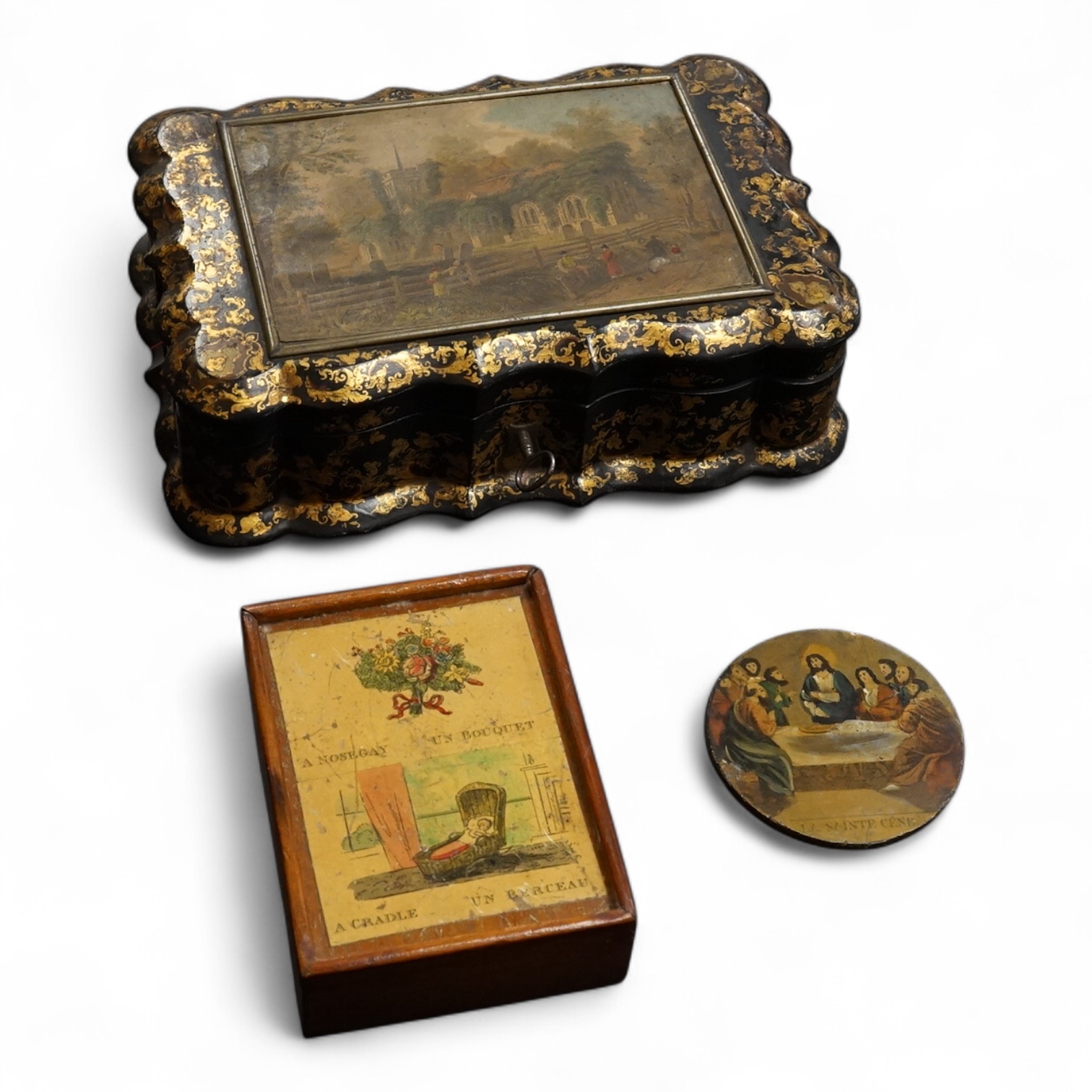 A Victorian Papier mache japanned sewing box, stamped ‘Lane, Birmingham’, the cover with a view of Chingford old church Essex, a boxed Victorian French translation game, by E C Spurin and a papier mache panel (3)